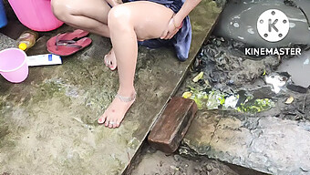 Indian Women Take A Bath In The Open Air