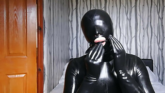 Latex-Clad Bondage Slave Gagged And Masked