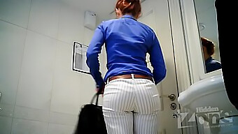 Hidden camera captures a stunning woman using the restroom