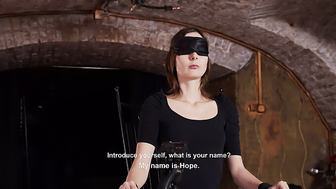 An enslaved submissive is interrogated while blindfolded in BDSM video